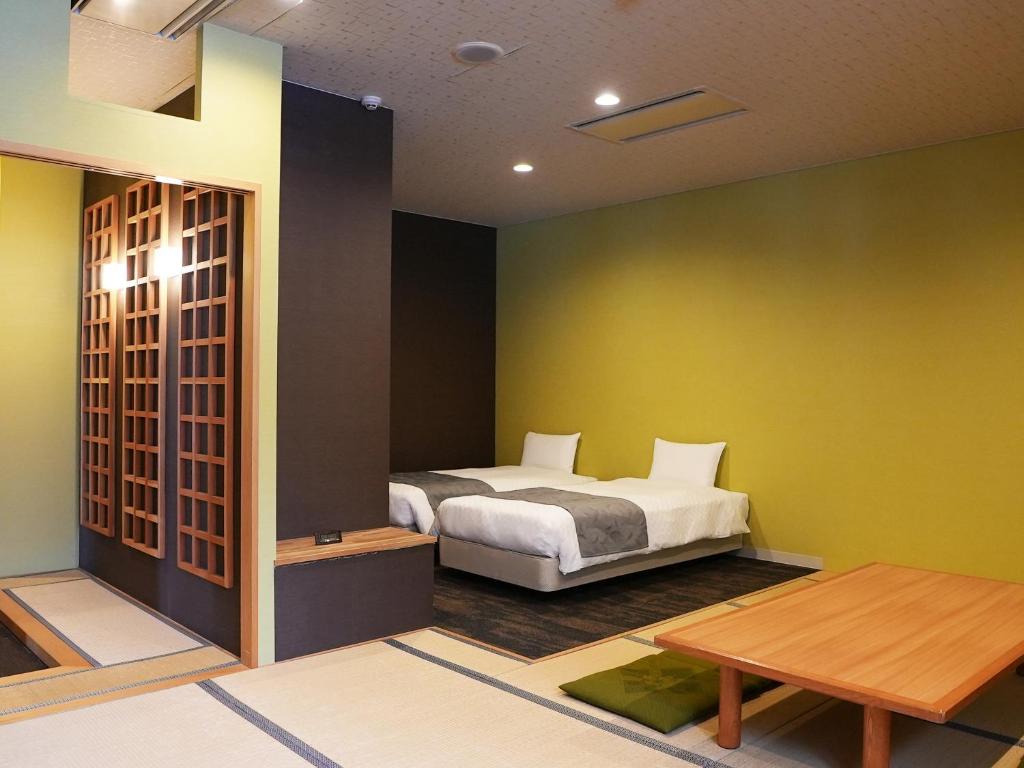 Postel nebo postele na pokoji v ubytování Hotel Abest Hakuba Resort