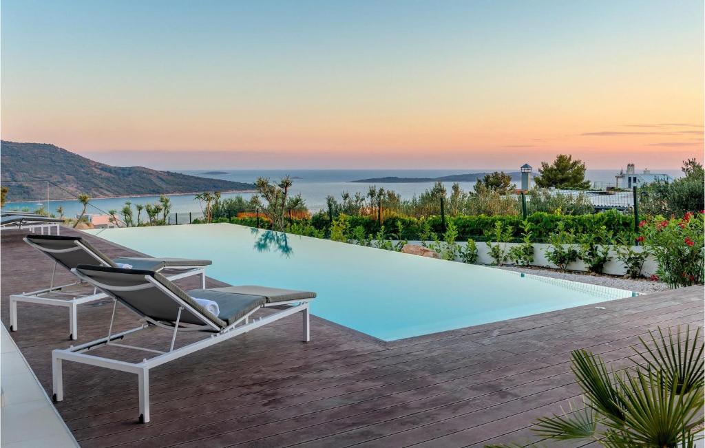 Una piscina con dos tumbonas al lado. en Villa Sunray 1, en Šibenik