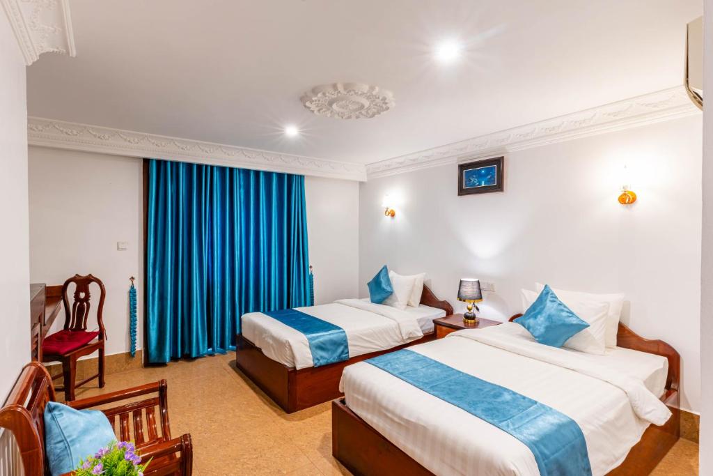 Postel nebo postele na pokoji v ubytování Rithy Rin Angkor Hotel