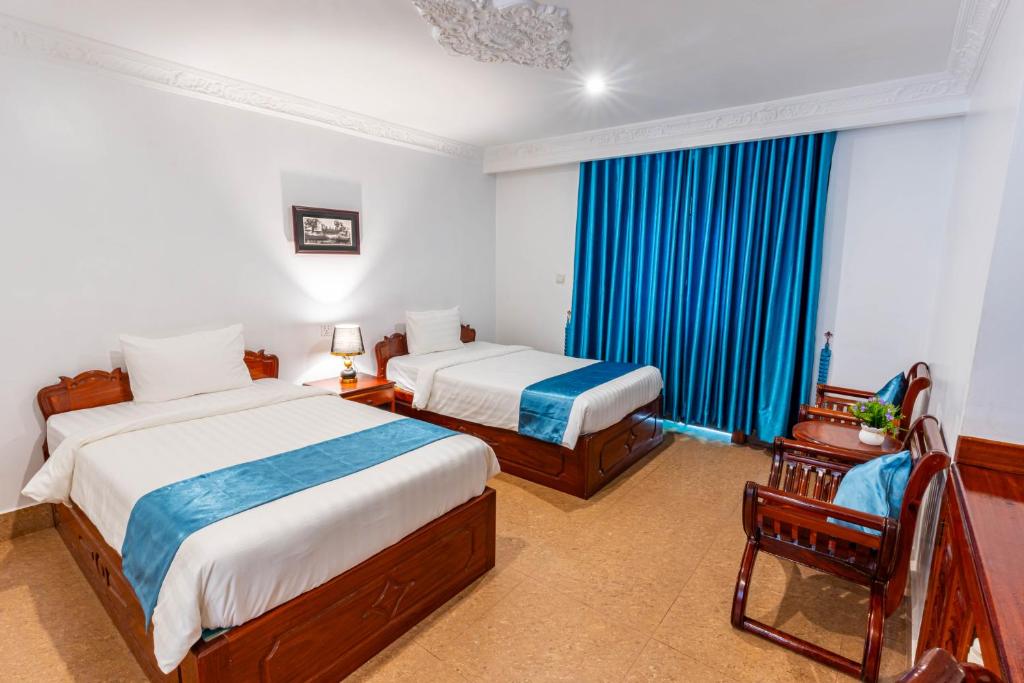 Postel nebo postele na pokoji v ubytování Rithy Rin Angkor Hotel