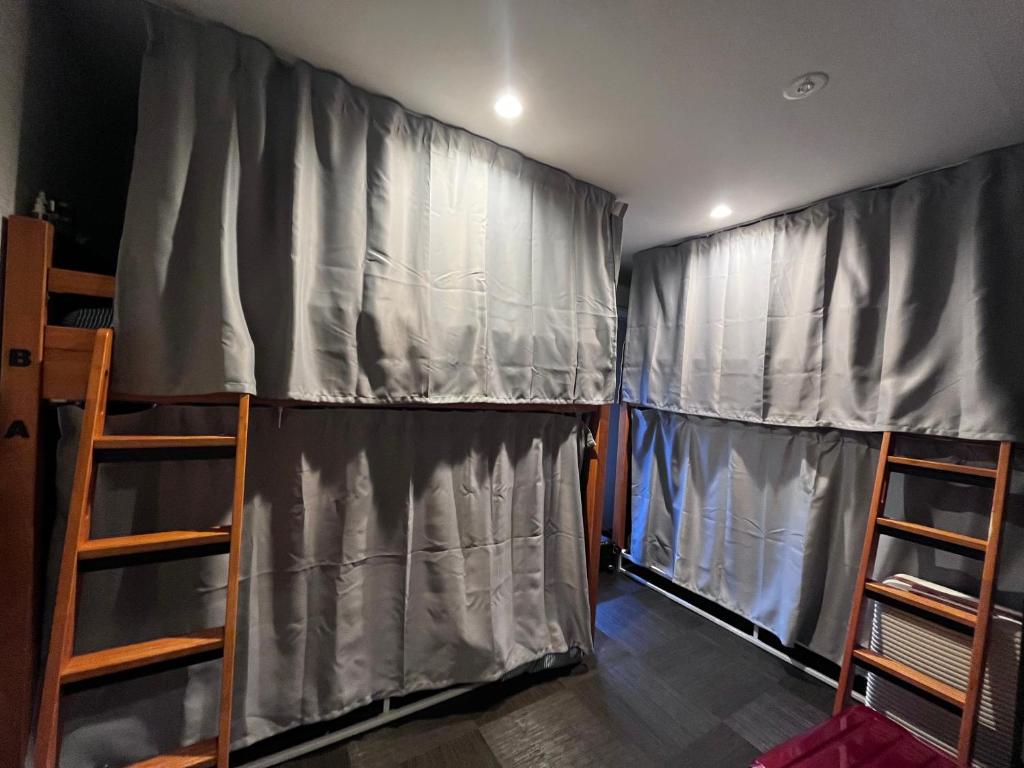 Postel nebo postele na pokoji v ubytování Mini Inn Kyoto-外国人向け - 日本人予約不可