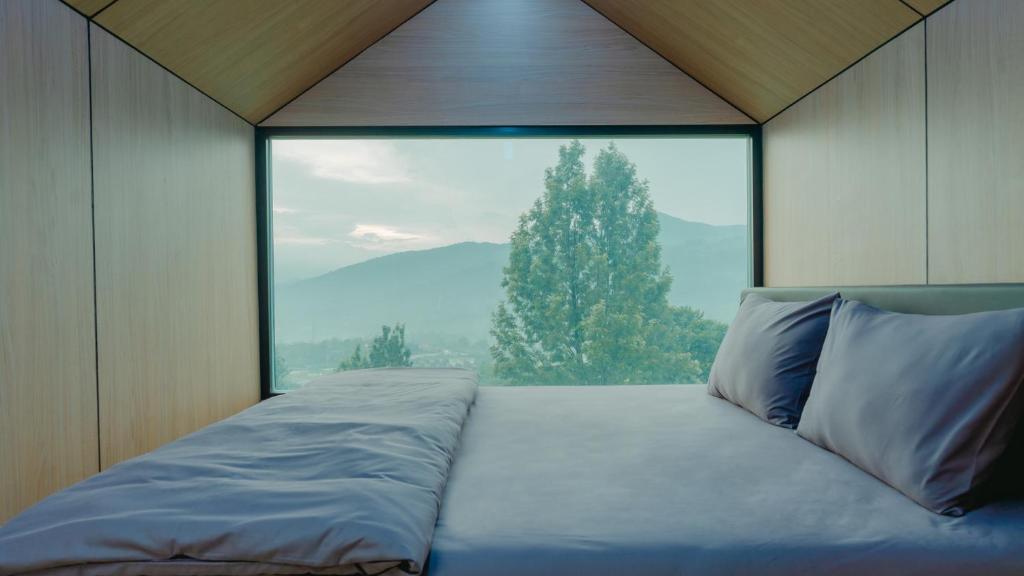 Postel nebo postele na pokoji v ubytování Bobocabin Gunung Mas, Puncak
