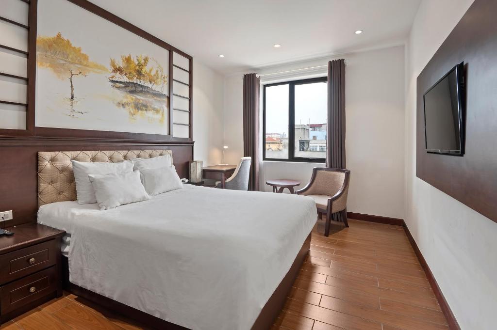 Postel nebo postele na pokoji v ubytování Bradi Gate- 22Land Residence Hotel