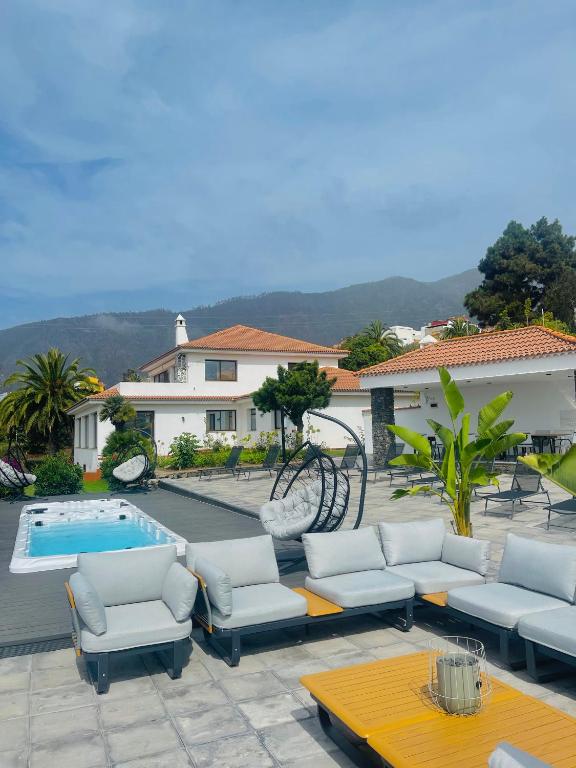 a patio with chairs and a bike next to a pool at Villa SOHLARA in La Orotava