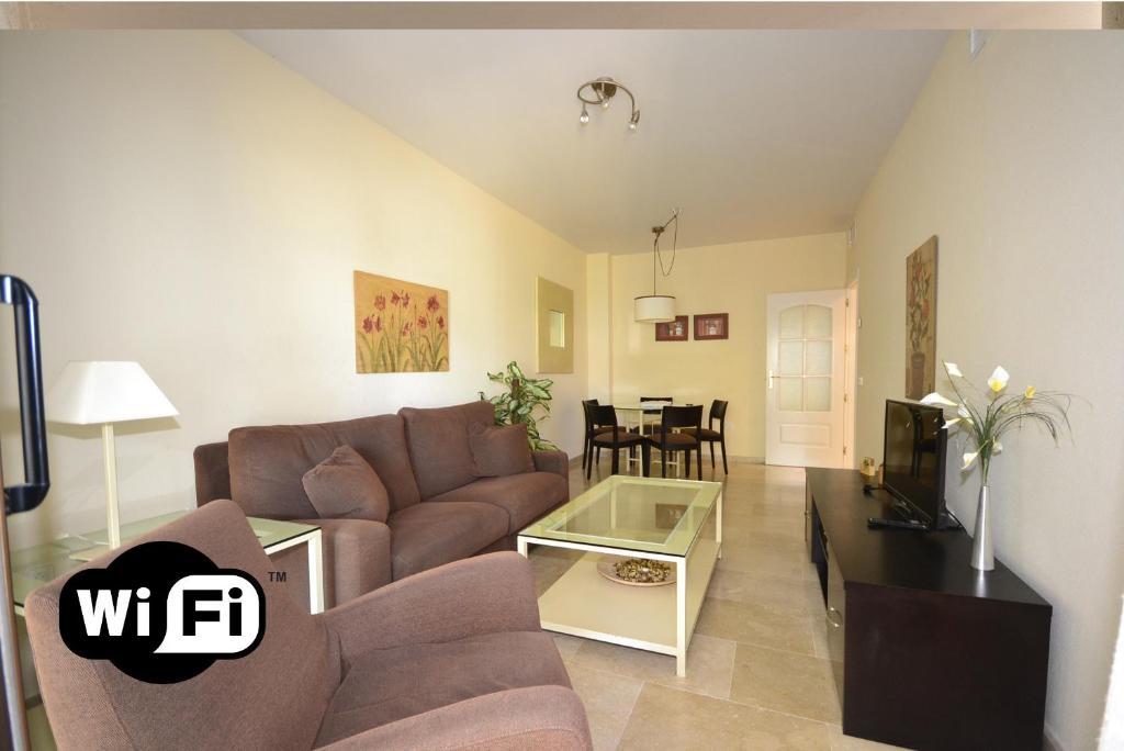 a living room with a couch and a table at marina duquesa 616 in Manilva