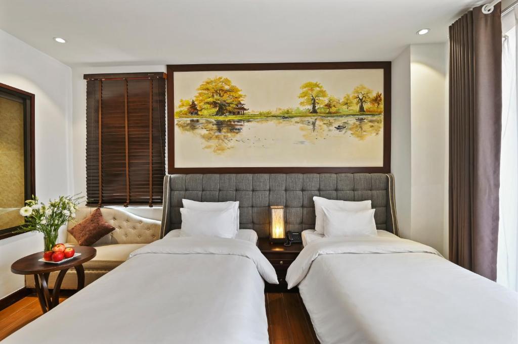 Postel nebo postele na pokoji v ubytování Bradi Gate- 22Land Residence Hotel