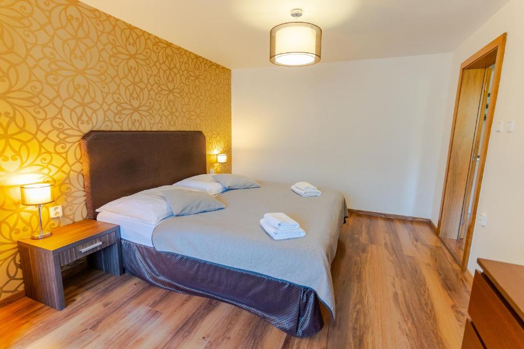 Postel nebo postele na pokoji v ubytování Hotel Ostredok
