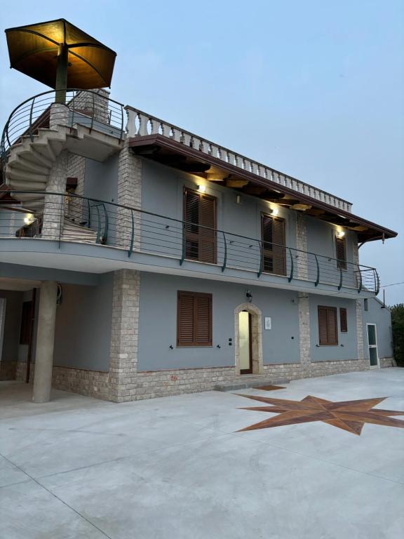 a building with a star in front of it at Affittacamere Melara in Serre