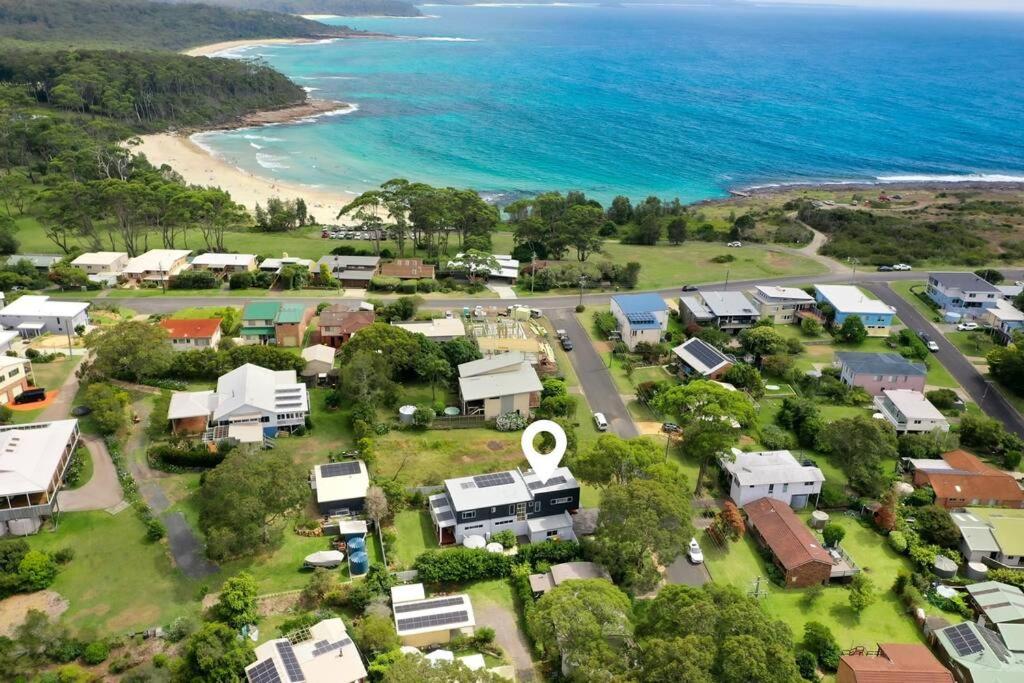 an aerial view of a village next to the ocean at Bawley Beach Escape in Bawley Point