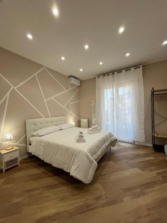 a bedroom with a large bed and a large window at Casa Miriam 281 in Palermo