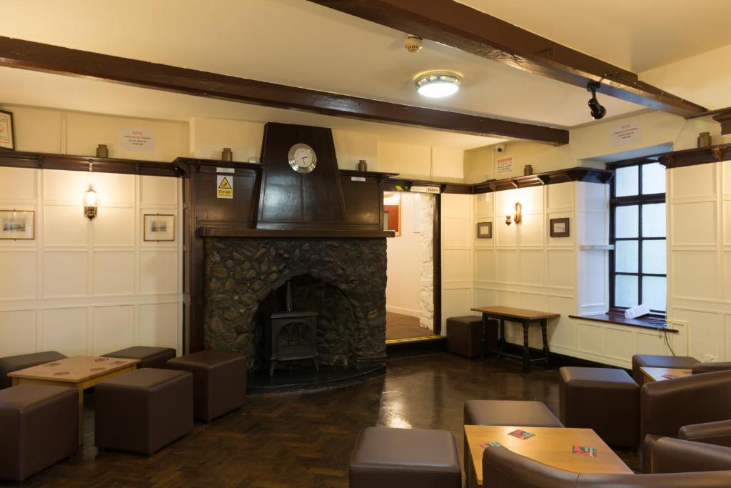 a living room filled with furniture and a fireplace at Drovers Arms Hotel in Carmarthen