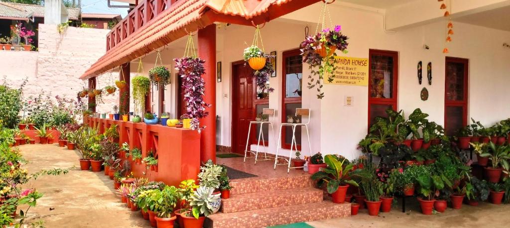 a flower shop with potted plants in front of it at Holidayincoorg - Brick lane in Madikeri