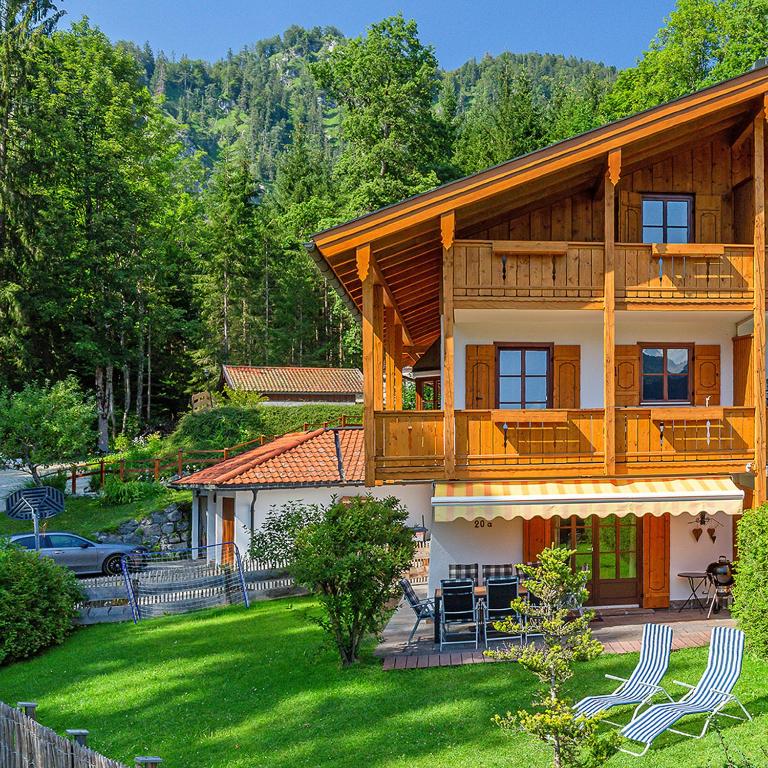 a large wooden house with a balcony and a yard at Ferienhaus Thimlefi in Reit im Winkl