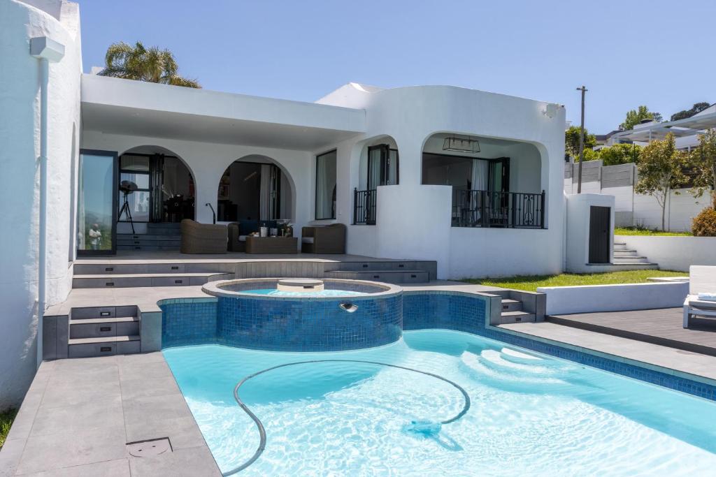a swimming pool in front of a house at Waveren's Nest in Cape Town
