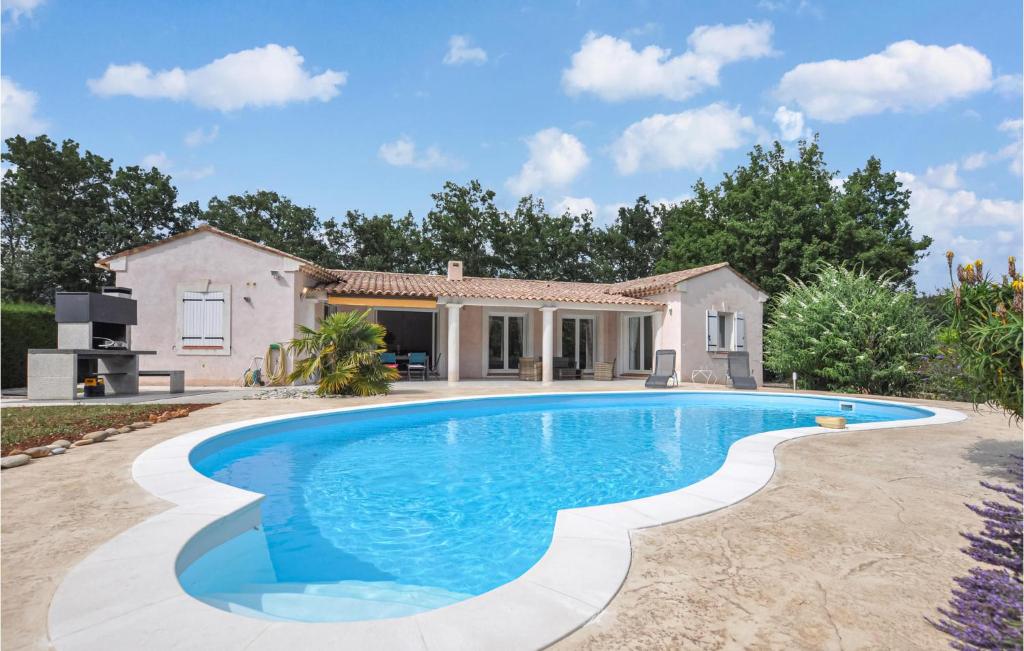 a villa with a swimming pool in front of a house at Nice Home In Saint-Cézaire-Sur-Siagne in Saint-Cézaire-sur-Siagne