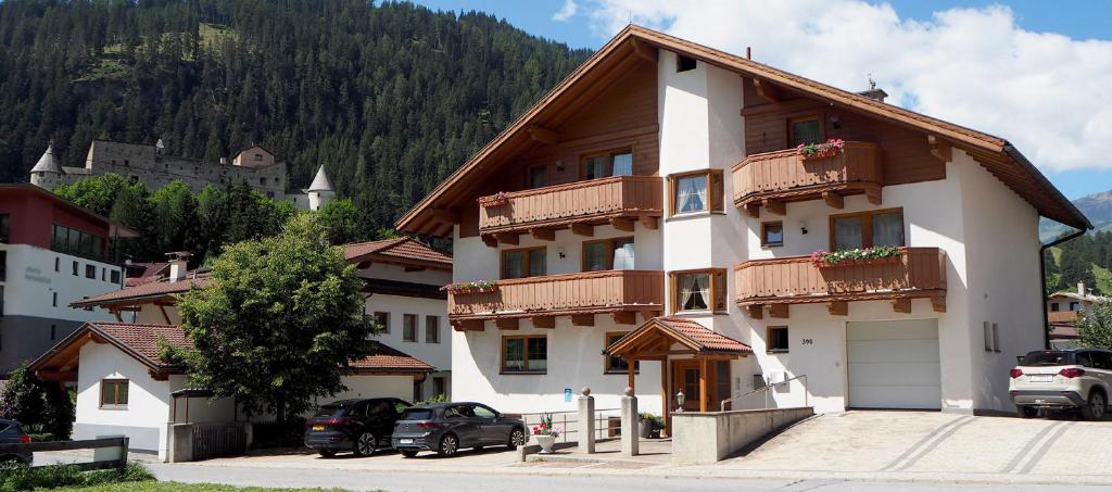 a large building with cars parked in front of it at Valdafur Suites in Nauders