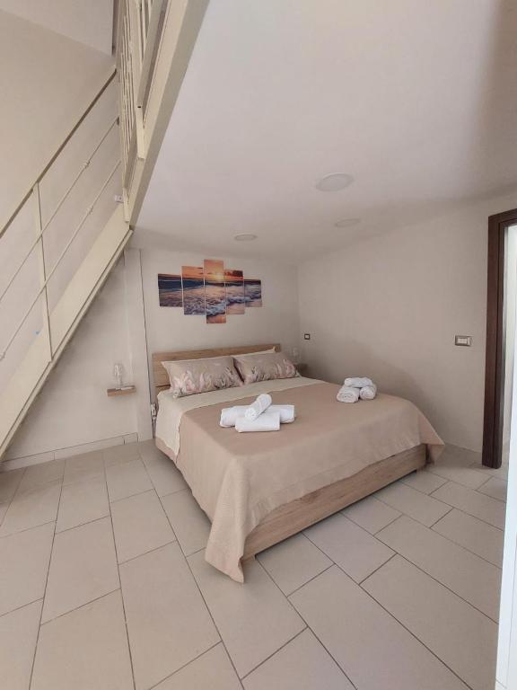 a bedroom with a bed with two towels on it at Tarantè Apartment in Naples