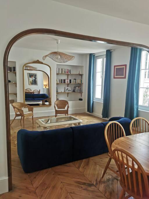 un salon avec un canapé bleu et une table dans l'établissement La voûte de Jeanne, à Orléans