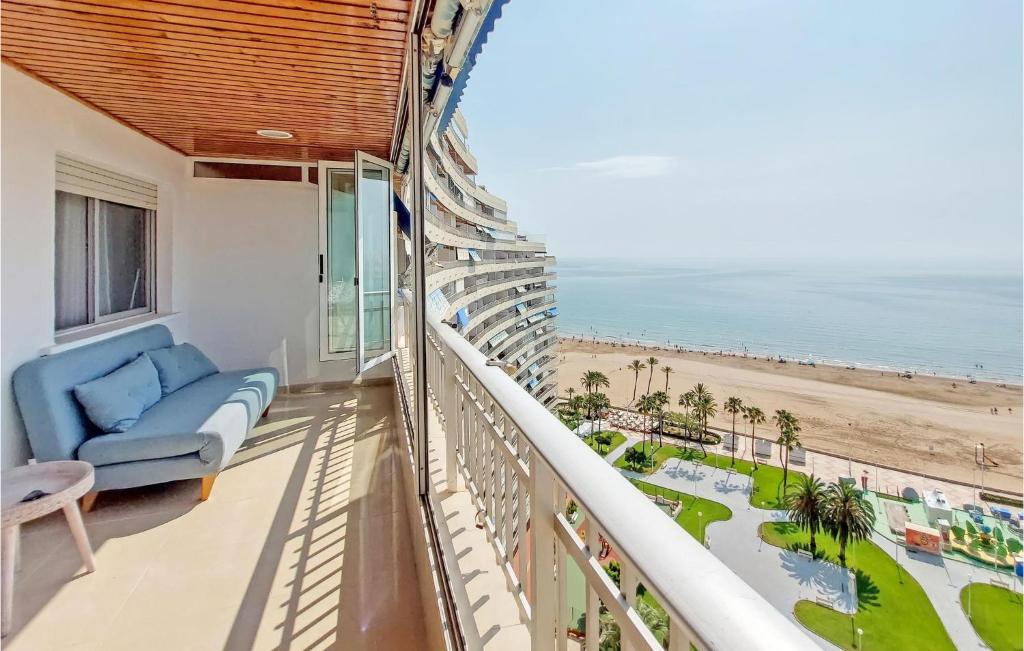 a balcony with a blue couch and a view of the beach at 1 Bedroom Nice Apartment In Cullera in Cullera