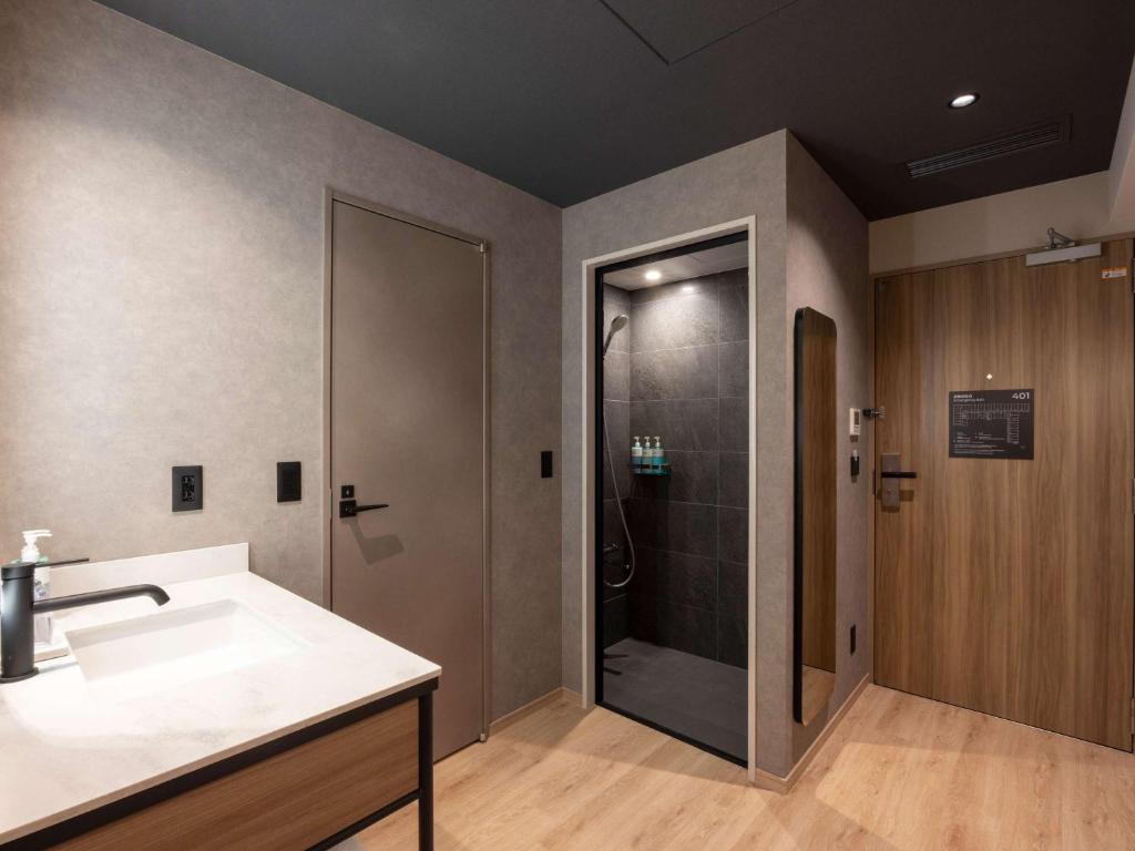 a bathroom with a shower and a sink at Novotel Nara in Nara