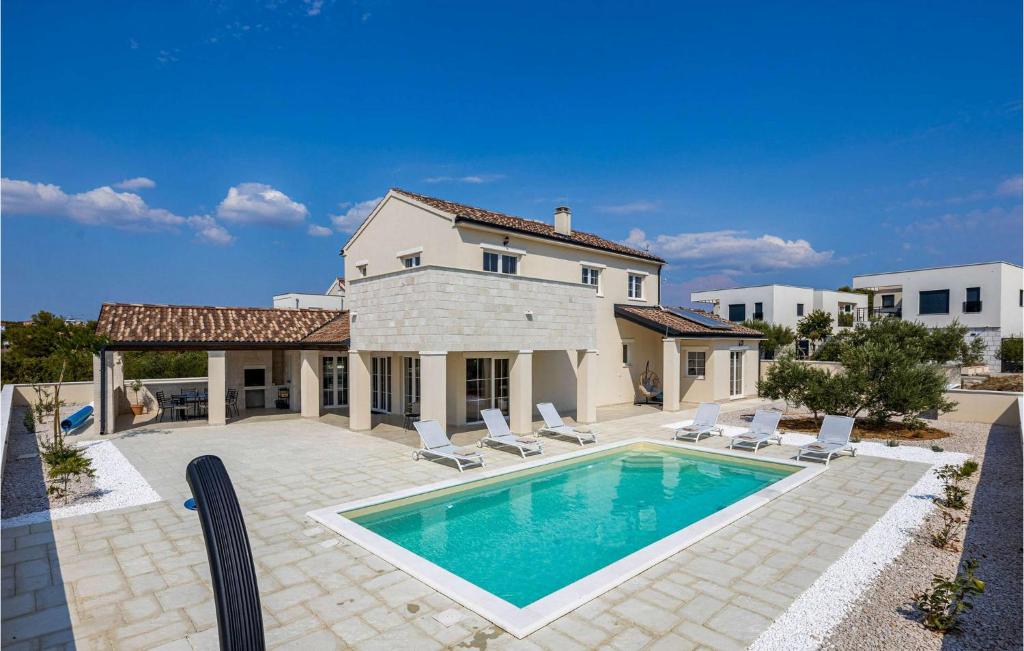 a villa with a swimming pool and a house at Villa Stina Murter in Jezera