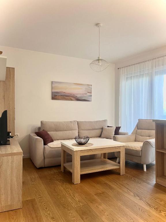 a living room with a couch and a coffee table at Apartment VacationVibes Mostar in Mostar