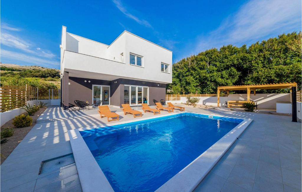 a villa with a swimming pool in front of a house at Villa Valentina in Pag