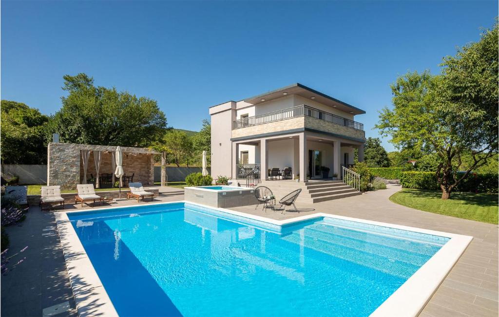 a swimming pool in front of a house at Villa Dali in Sičane