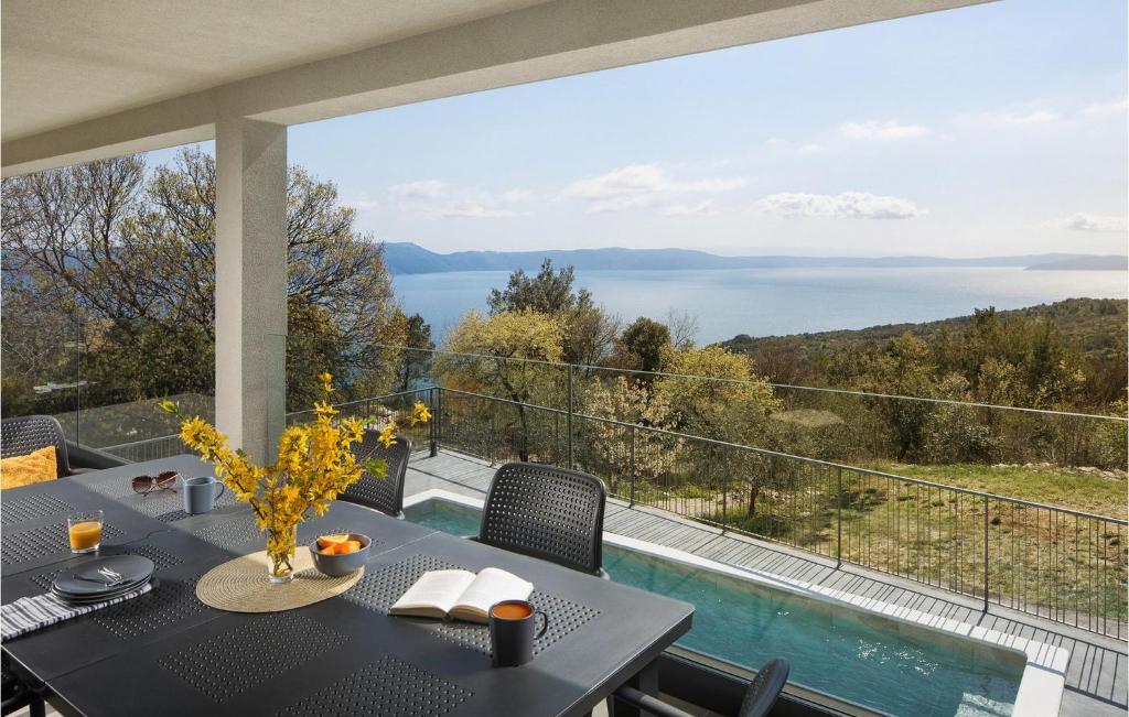 a dining room with a table and a view of the water at Villa Lipa in Labin