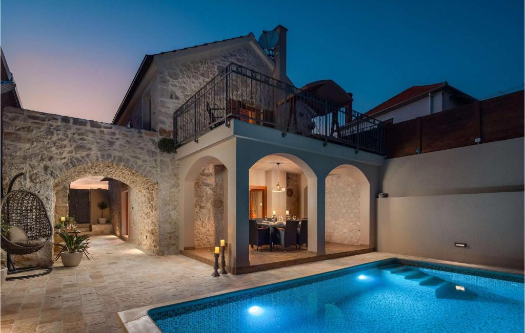 a house with a swimming pool in front of it at Villa Kameni Dvori in Sveti Filip i Jakov