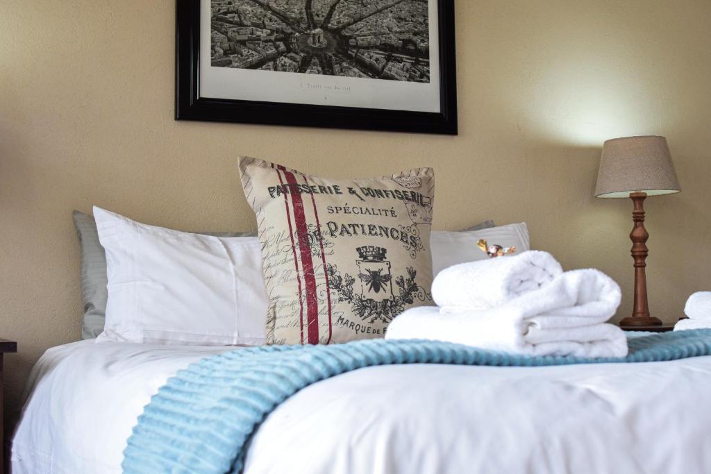 a bedroom with a bed with towels on it at DullVino Apartment 8 at Millers Cove in Dullstroom