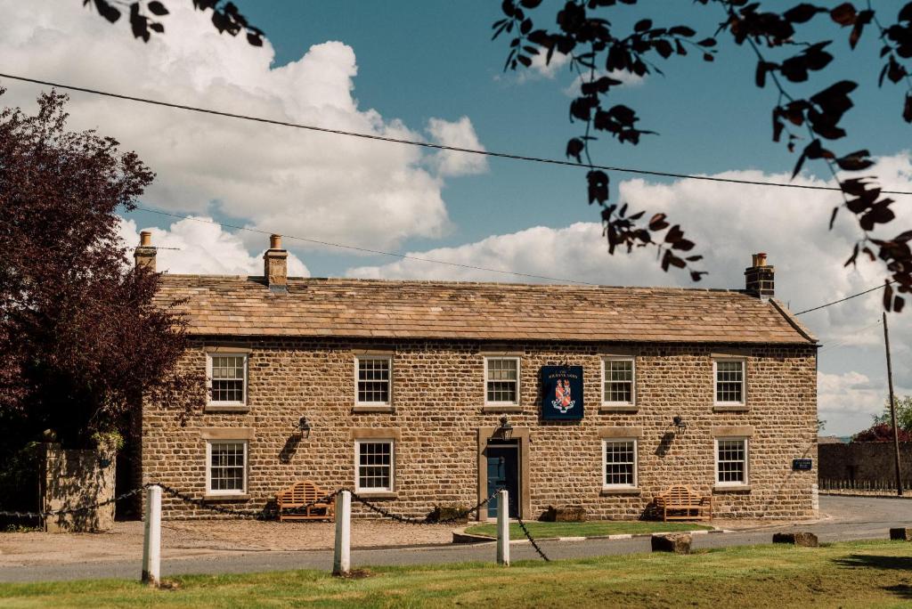 an old brick building with a flag on it at The Milbank Arms in Richmond
