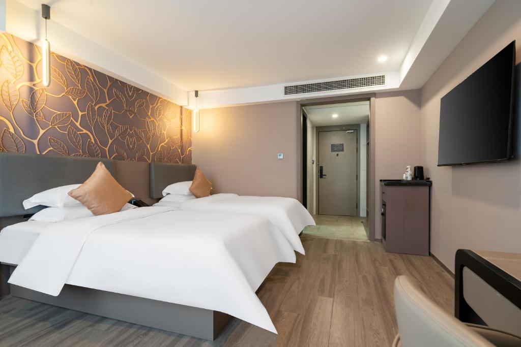 TV a/nebo společenská místnost v ubytování Ruilan Grandyard Hotel