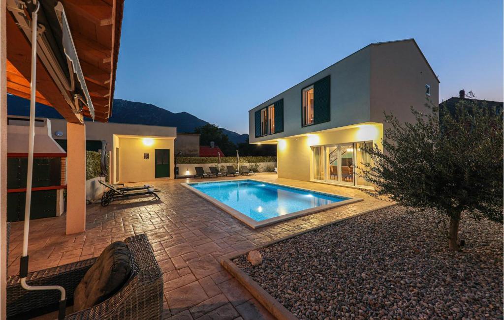 a house with a swimming pool in front of it at Stunning Home In Sestanovac in Šestanovac