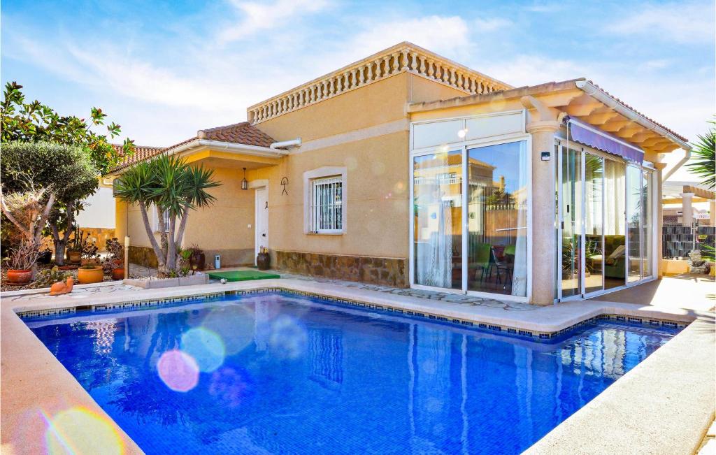 a swimming pool in front of a house at Stunning Home In Pulpí in Pulpí
