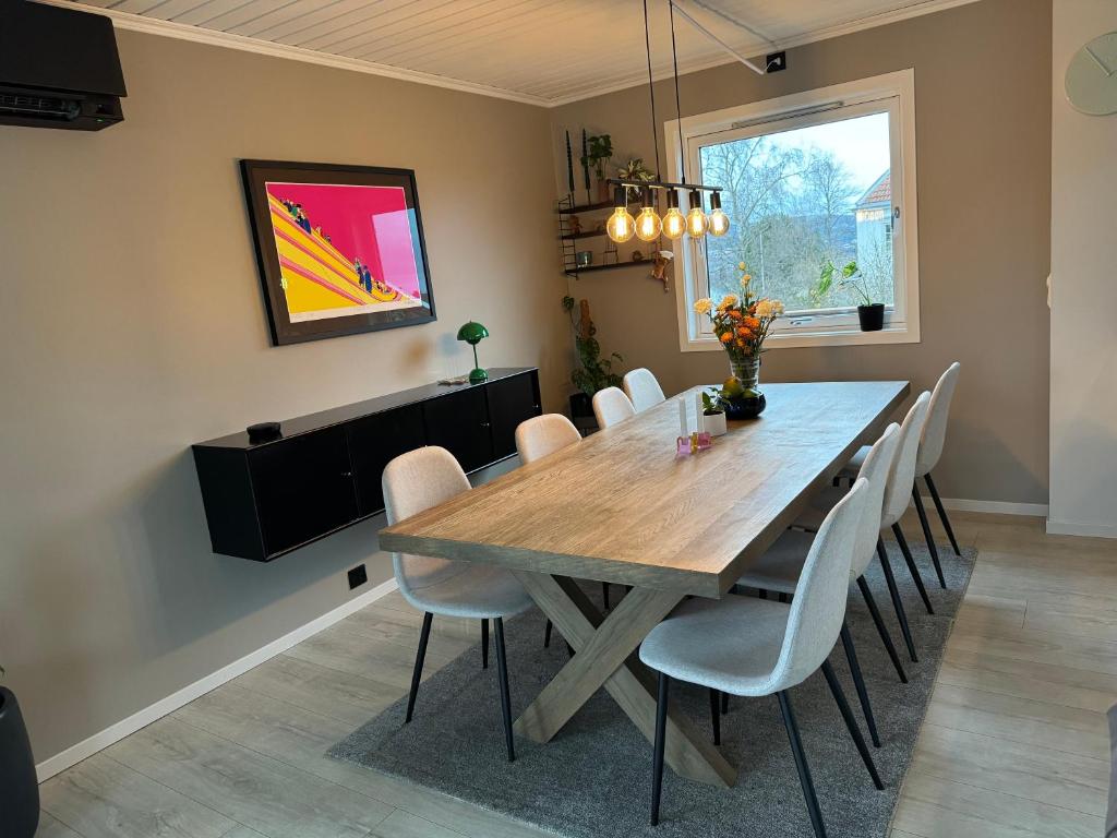 a dining room with a wooden table and chairs at Spacious house near city centre - WSC 2025! in Trondheim