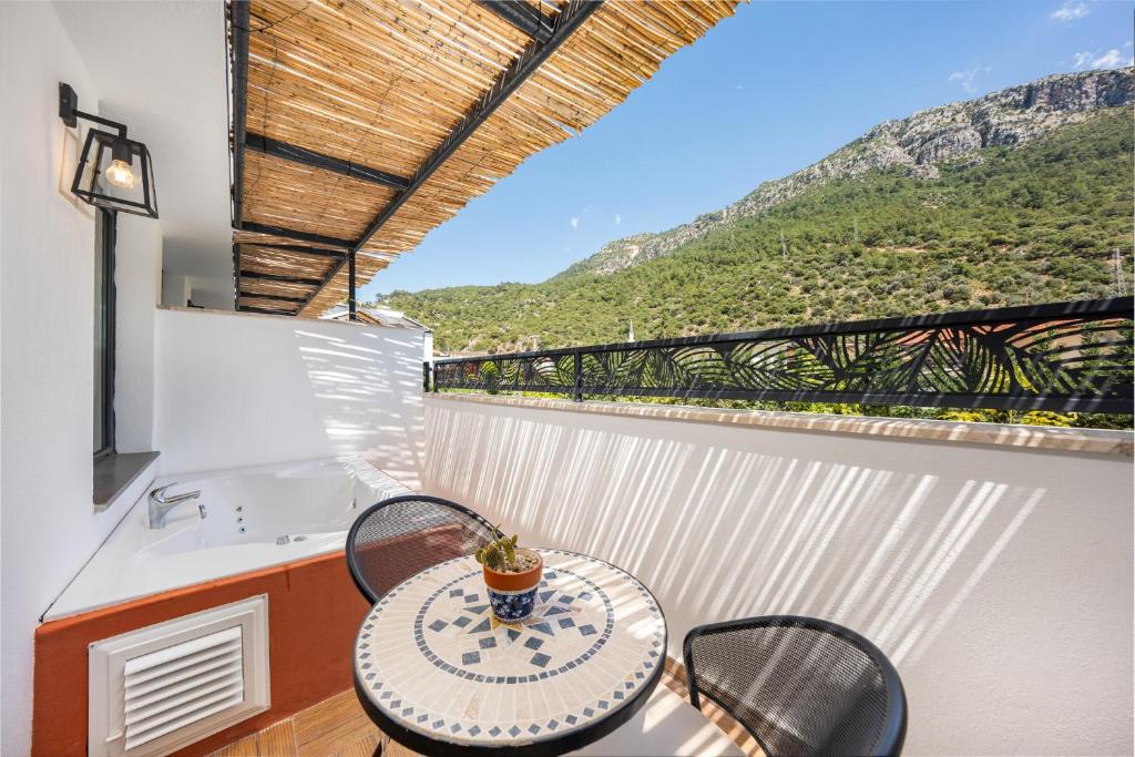 a table and chairs on a balcony with a view at Ölüdeniz Blu Luxury Unique Hotel - Adults-Only in Oludeniz