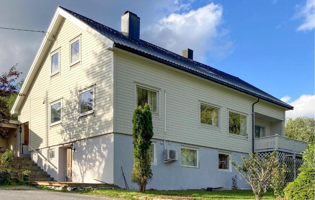 a white house with ivy on the side of it at 5 Bedroom Gorgeous Home In Hundeidvik in Hundeidvik