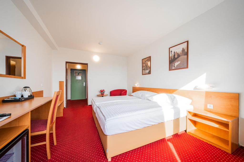 Postel nebo postele na pokoji v ubytování Hotel Globus