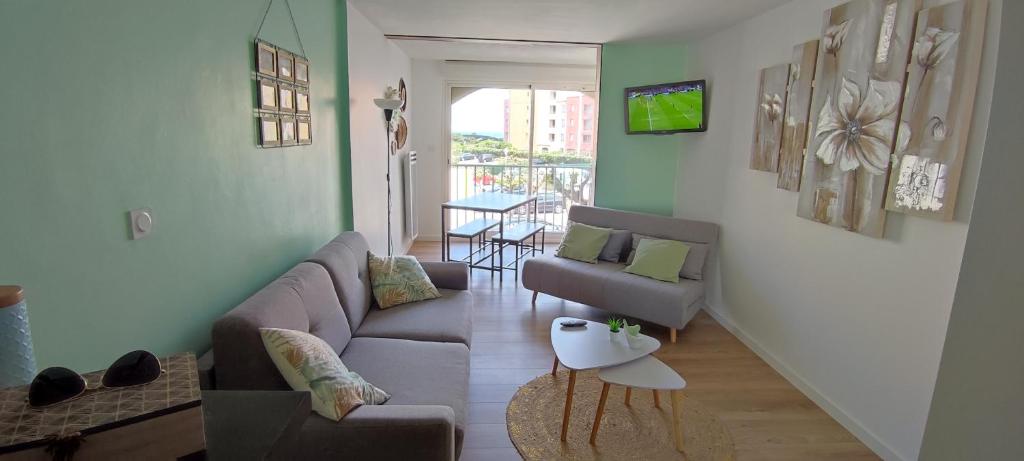 un salon avec un canapé et une table dans l'établissement STUDIO COSY, au Cap d'Agde