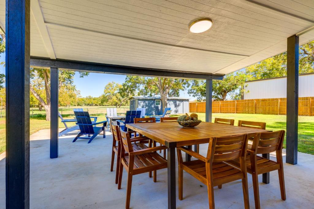 a patio with a wooden table and chairs at BBQ Ready and Fire Pit Chic Johnson City Home in Johnson City