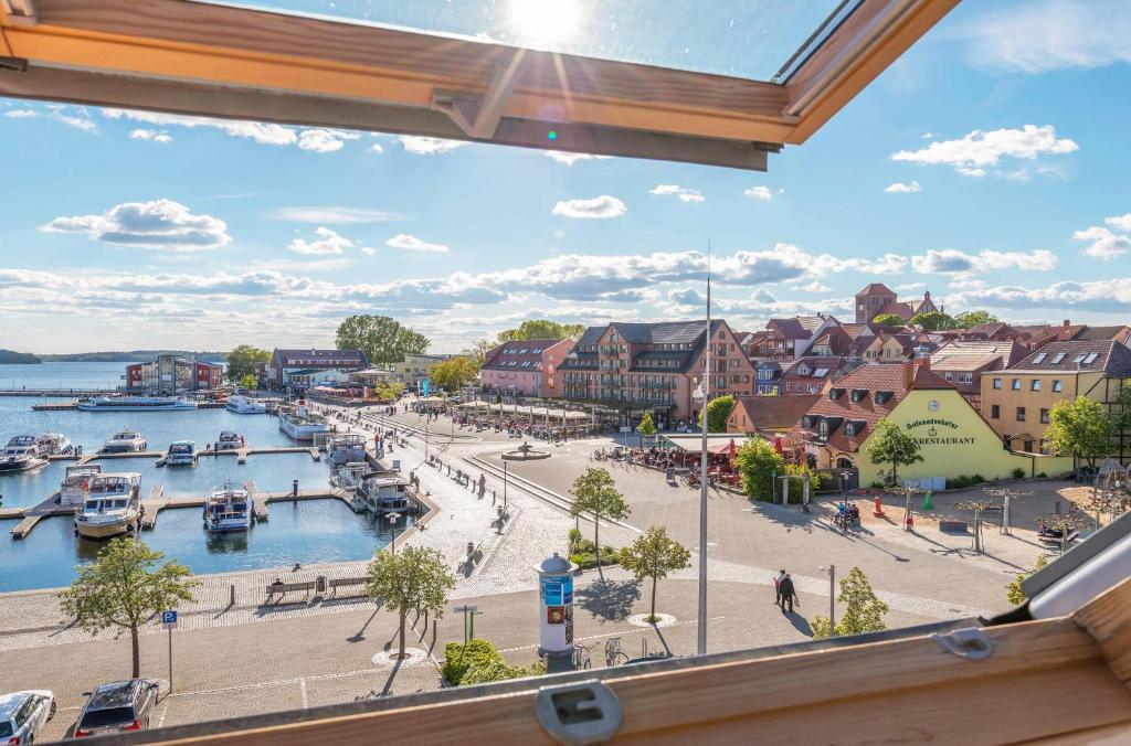 a view from a window of a harbor with boats at Ferienwohnung Seeblick - Ferienwohnung mit Ausblick auf den Yachthafen in Waren