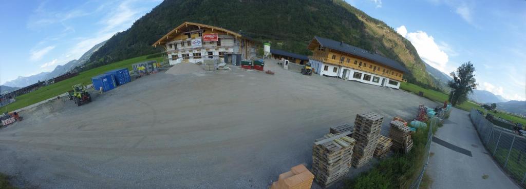 a large building in front of a mountain at Ferienwohnungen Bachmayerhof in Uderns