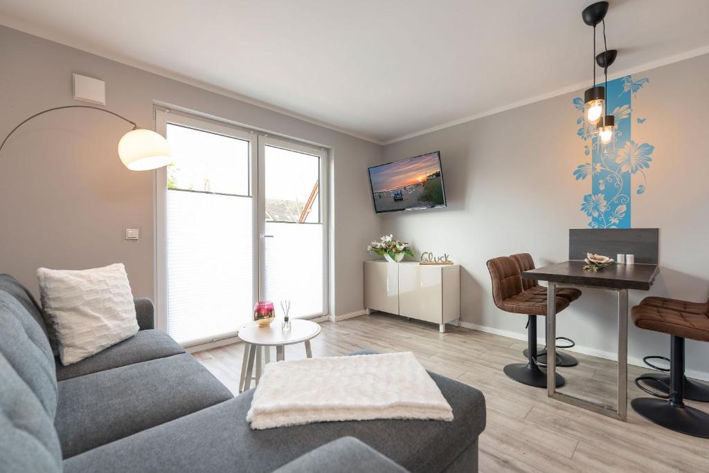 a living room with a couch and a table at Knuddi s Ferienhof, App 04 in Zempin