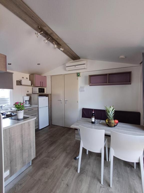 a kitchen and living room with a table and chairs at Camping Tucan - Mobile Homes by Lifestyle Holidays in Lloret de Mar