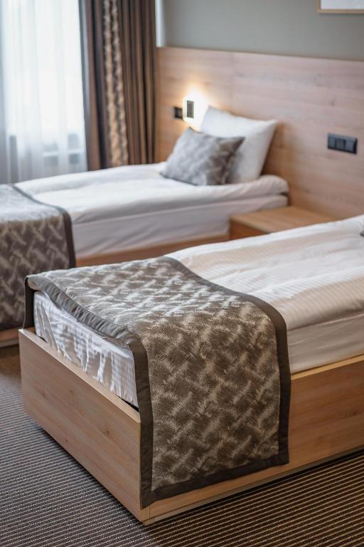 Postel nebo postele na pokoji v ubytování Rudison Hotel & Restaurant