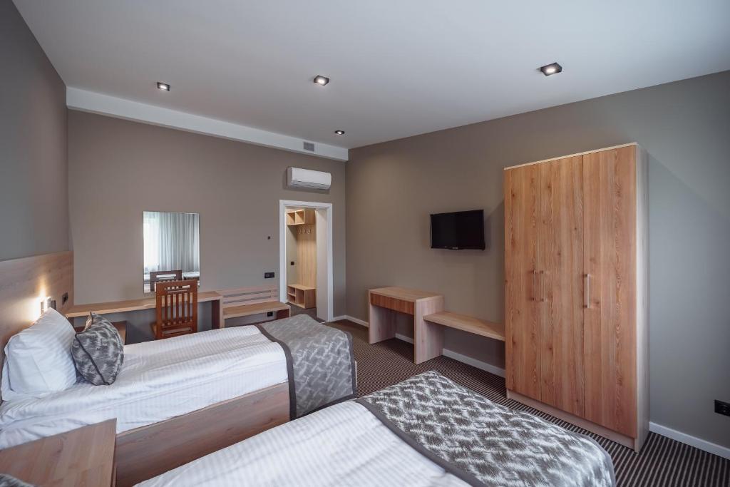 Postel nebo postele na pokoji v ubytování Rudison Hotel & Restaurant