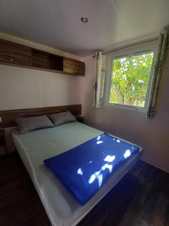 a bed in a room with a window at Camping Tucan - Mobile Homes by Lifestyle Holidays in Lloret de Mar