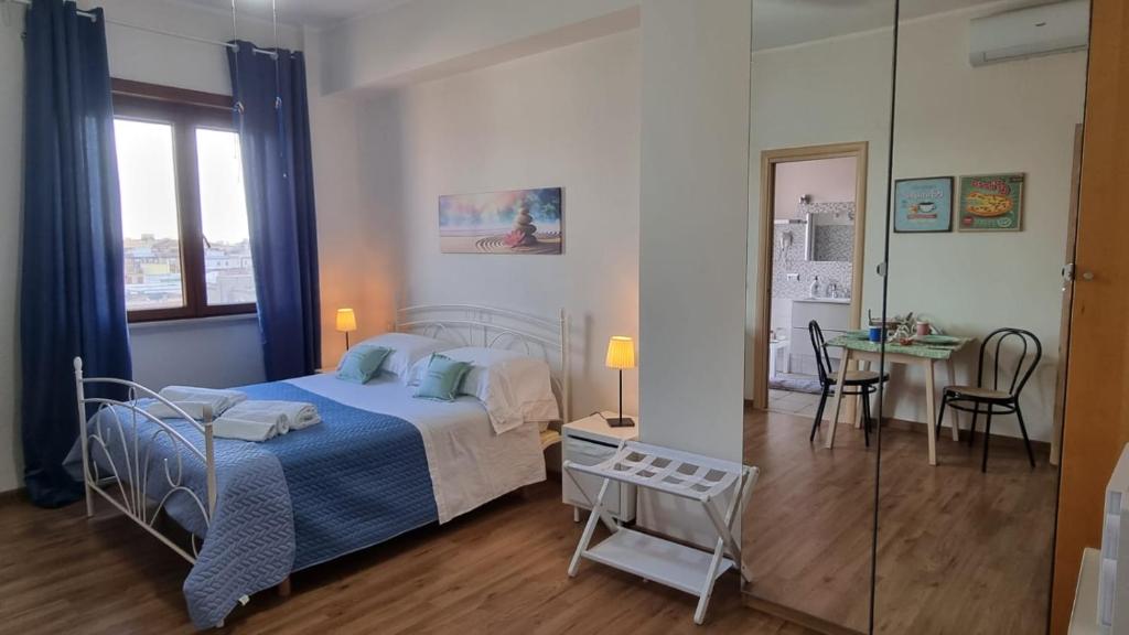 Postel nebo postele na pokoji v ubytování OLEANDRI SUITE B&B