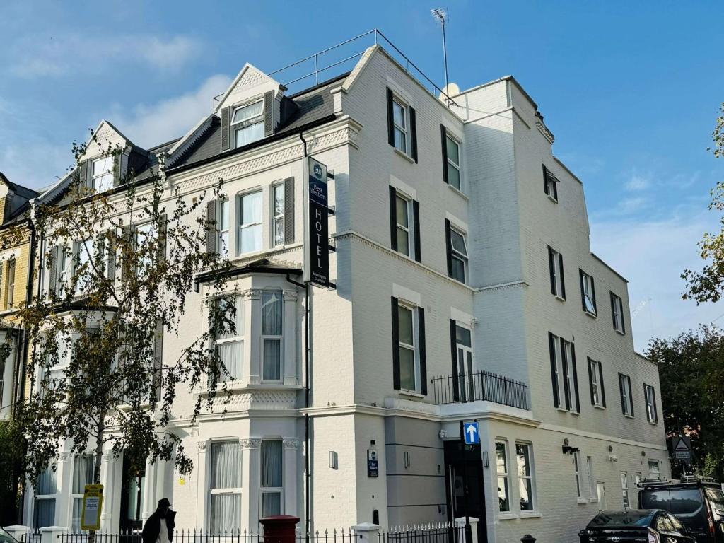 a large white building on a city street at Best Western Kensington Olympia Hotel in London